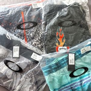 (4) pair Oakley Men's board shorts and swimsuits, size Large, NWT, fast ship